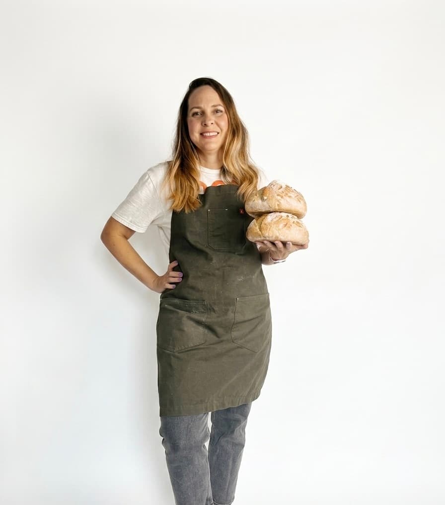 Anais — baker and founder of The Morning Crumbs, holding fresh sourdough loaves